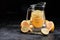 Summer healthy citrus lemonade in decanter. Cocktails of citrus with lime lemon, orange on black background