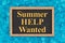 Summer Help Wanted word message on grunge chalkboard sign