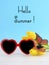 Summer Is Here concept with red heart shape sunglasses