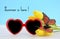 Summer Is Here concept with red heart shape sunglasses