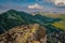 Summer hiking in the mountains with massive rocks, dramatic skies and majestic mountains.