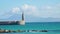 Summer holiday at the beach. South of Spain. Mediterranean coast. Turquoise sea. Lighthouse pier