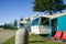 Summer holiday caravans parked under Norfolk Pine tree