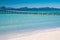 Summer holiday concept photo. Sea and empty pier. Beautiful clear tropical beach, white sand and blue water. Spain