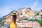 Summer holiday in Italy. Young woman in Positano village on the background, Amalfi Coast, Italy