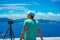 Summer holiday visiting Greece. Male photographer enjoying to capture time lapse cloudscape, coastline and sea with