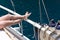 Summer holiday on the yacht. Beautiful female feet on blue sea background.