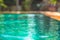 Summer holidays blurred background with swimming pool with turquoise water