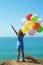 summer holidays, celebration, family, children and people concept - happy girl with colorful balloons