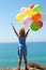 summer holidays, celebration, family, children and people concept - happy girl with colorful balloons