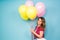 Summer holidays, celebration, woman and people concept - happy woman with colorful balloons indoors, background with