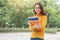 Summer holidays, Education, Campus and teenage concept - Smiling female student in black eyeglasses with folders and group in the