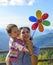 Summer holidays, family, children and people concept - happy mother and child girl with pinwheel toy