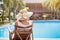 Summer holidays in luxury hotel, woman relaxing in deckchair