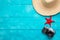 Summer holidays and vacation travel concept. Vintage camera, straw hat and red starfish on pastel blue background. Top view and