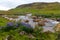 Summer Iceland panorama on river shore among green grassland and lupins.