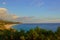 Summer Ionian Sea coastline view on the sunset with green bushes in front, Albania