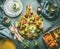 Summer or Italian food still life with kitchen table, colorful fresh sliced tomatoes , mozzarella, plates and cutlery.