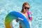 Summer kids Cocktail. Happy little boy with colorful inflatable ring in outdoor swimming pool on hot summer day. Family