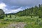 Summer landscape in Altai mountains with creek, alpine meadow and coniferous forest