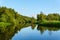 Summer landscape of a calm oxbow lake with wooded shores