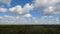 Summer landscape with field of grass,blue sky timelapse. Green Grass Field Landscape with fantastic clouds in the