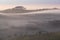 Summer landscape with fog in valley above river, foggy morning. Landscape of fields with grass in the morning.