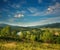 Summer landscape in mountains of Carpathians river in alley village and pine forests