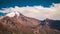 Summer landscape in mountains and dark blue sky. Time lapse. Stock. Timelapsed scenery with mountain peaks and cloudy