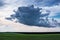 Summer landscape, over a green field huge cloud_