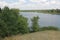 Summer landscape with a pond, forest and steppe