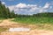 Summer landscape. Puddle on the rural dirt road along the forest, Moscow suburbs, Russia.