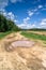 Summer landscape. Puddle on the rural dirt road along the forest, Moscow suburbs, Russia.