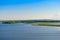 Summer landscape with a river, islands, and blue sky