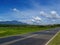 Summer landscape with road through rural land. Tropical nature bright view from highway