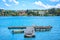 Summer landscape with sea, wooden pier, white fisher boat