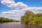 Summer landscape with small river flowing between wooded banks. Russia, Ryazan, Trubezh river