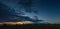 Summer landscape with storm sky over rye field