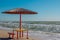 Summer landscape: table, benches and shade umbrella