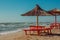 Summer landscape: table, benches and shade umbrella on the beach