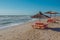 Summer landscape: table, benches and shade umbrella on the beach