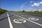 Summer landscape with two road signs `Bicycle path`