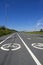 Summer landscape with two road signs `Bicycle path`