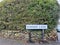 Summer Lane street sign in Sheffield Yorkshire UK on path with Wall and hedge and road