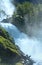 Summer Latefossen waterfall on mountain slope (Norway).