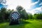 Summer leisure activity concept, copy space. Big inflatable darts on the lawn. Preparing for team building