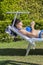 Summer lifestyle portrait of young stunning woman lying on the sunbed on the beach of the tropical island