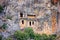 Summer mediterranean cityscape - view of the ruins of ancient Greek tombs in the ancient city of Myra, near the Turkish town of De