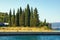 Summer Mediterranean landscape with silhouettes of green cypress against sky. Montenegro