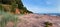 Summer midnight landscape on Baltic sea shore with stones, red r